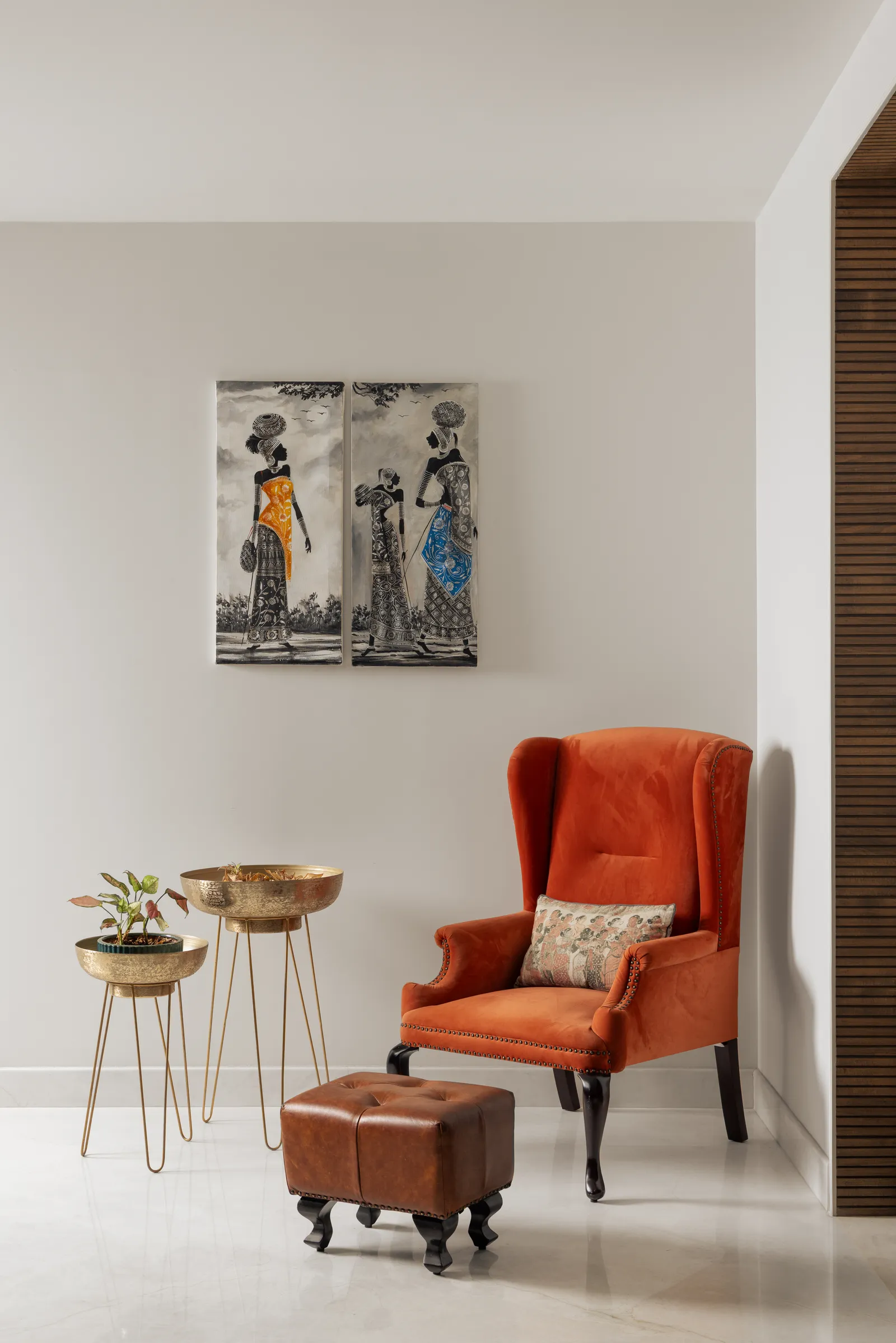 Corner with orange wingback chair and framed artwork — Seema Katta Svasa